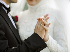 close up on couple holding hands together at wedding