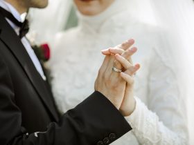 close up on couple holding hands together at wedding