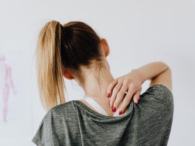 woman touching her back