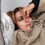 a woman pressing her nose bridge