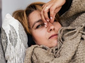 a woman pressing her nose bridge