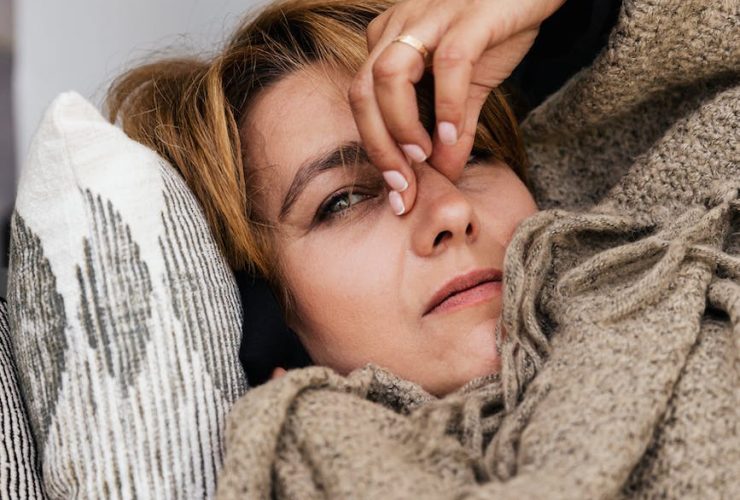 a woman pressing her nose bridge