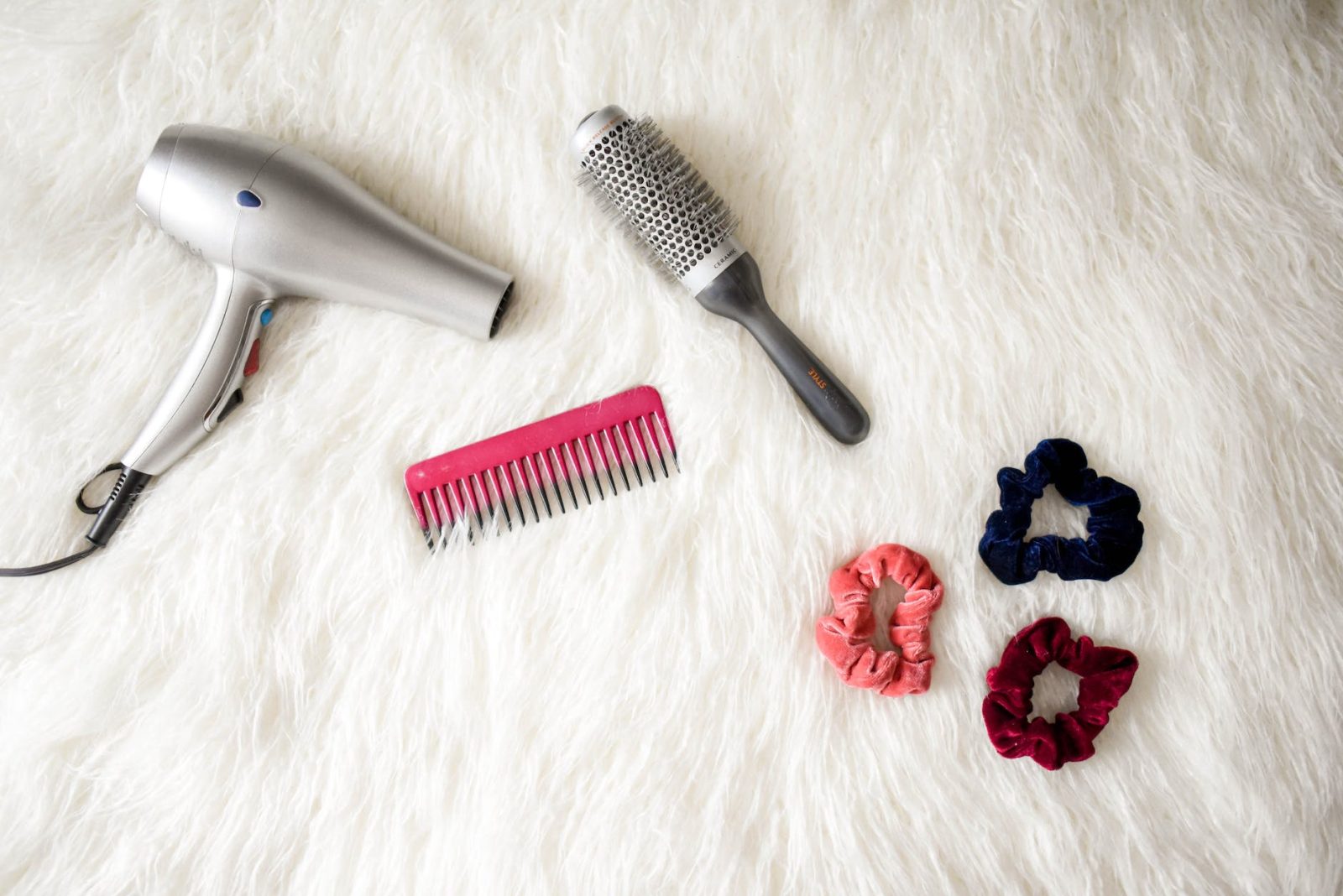 grey hair blower near pink hair combs and scrunchies