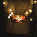 person holding string lights