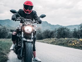 a man riding a motorcycle down a curvy road
