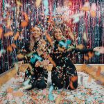 two women enjoying confetti