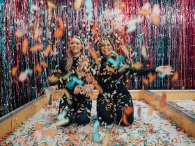 two women enjoying confetti