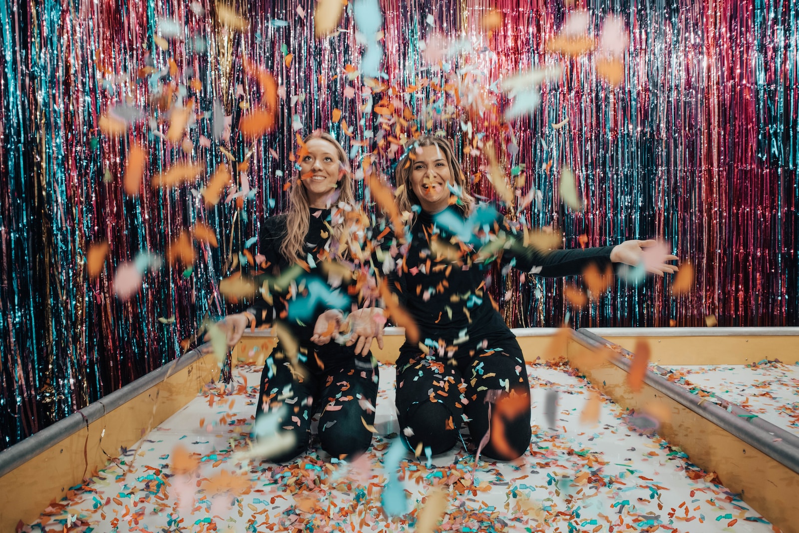 two women enjoying confetti