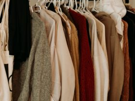 brown and white coat hanged on rack