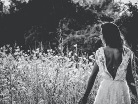 grayscale photography of woman in backless wedding gown