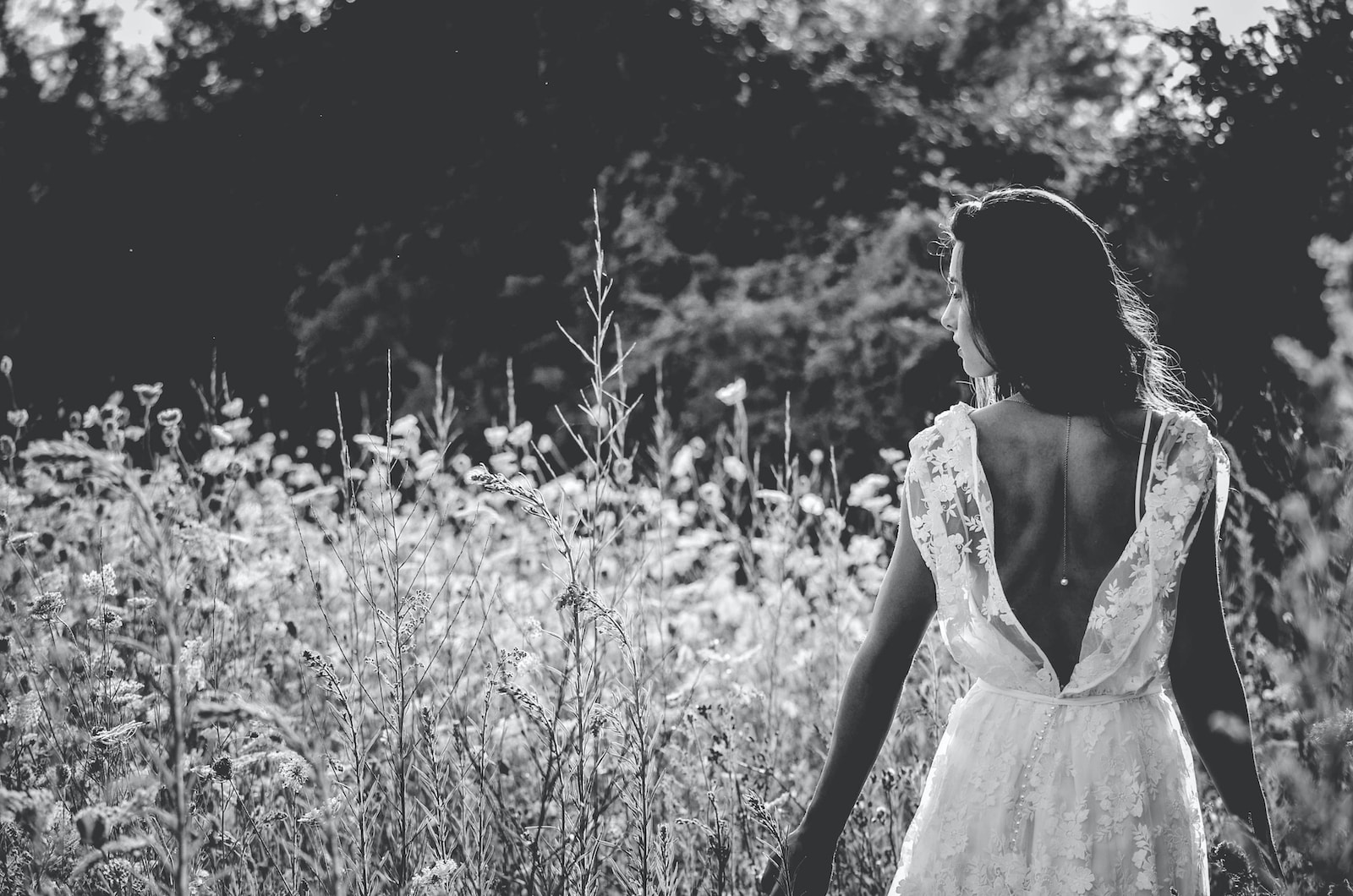 grayscale photography of woman in backless wedding gown