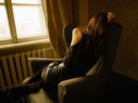 woman sitting on wing chair