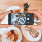 person taking picture of the foods