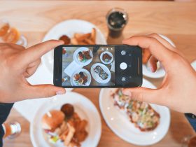 person taking picture of the foods