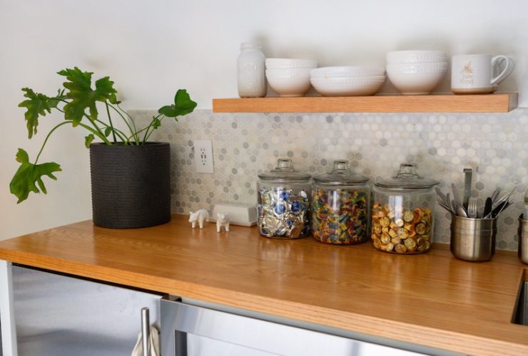 a kitchen counter with a microwave and a potted plant