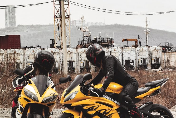 man in black helmet riding yellow sports bike during daytime