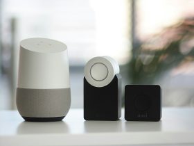 white and gray Google smart speaker and two black speakers