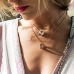 woman wearing gold-colored ring pendant necklaces