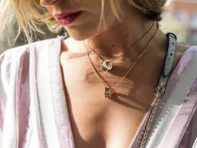 woman wearing gold-colored ring pendant necklaces