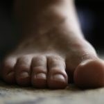 a close up of a person's bare foot on the floor