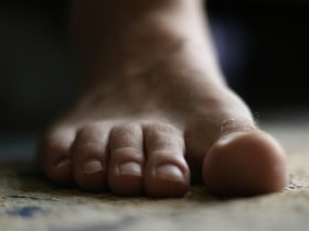 a close up of a person's bare foot on the floor