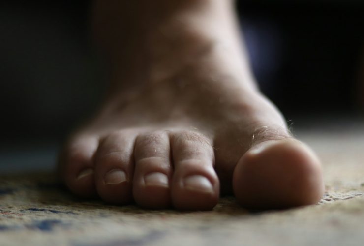 a close up of a person's bare foot on the floor