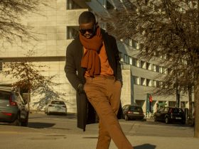 a man in brown pants and an orange scarf