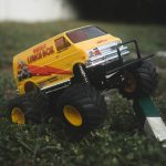 yellow and black truck toy on green grass