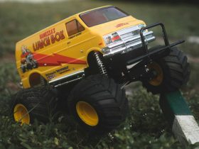 yellow and black truck toy on green grass