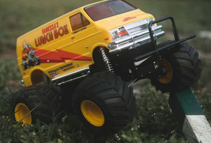 yellow and black truck toy on green grass