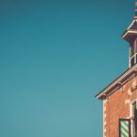 brown brick building under blue skies