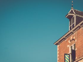 brown brick building under blue skies