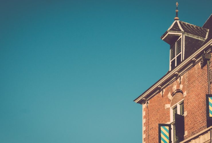 brown brick building under blue skies