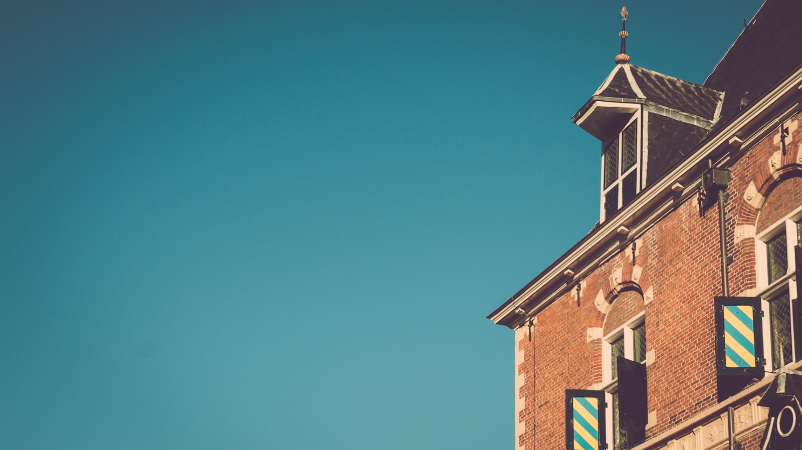 brown brick building under blue skies