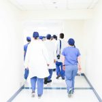 group of doctors walking on hospital hallway