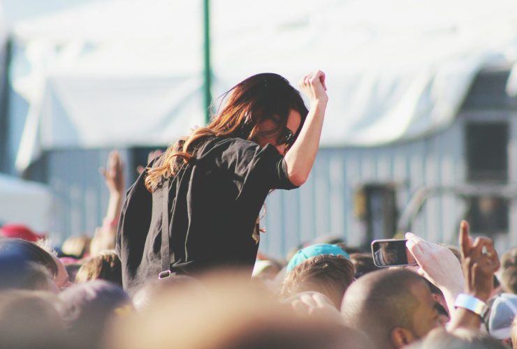 woman on top of crowd