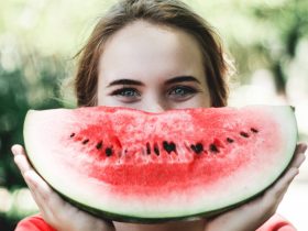 woman holding sliced watermelon