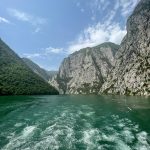 a body of water with mountains in the background
