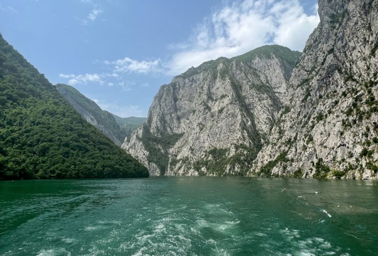 a body of water with mountains in the background