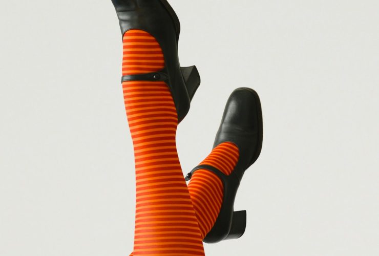 woman wearing pair of black leather chunky-heeled shoes
