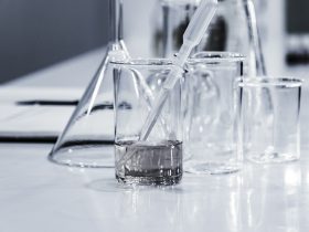 three clear beakers placed on tabletop