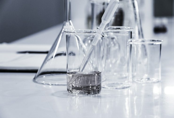 three clear beakers placed on tabletop