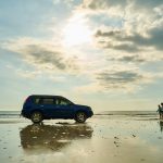 blue suv on beach during daytime