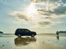 blue suv on beach during daytime