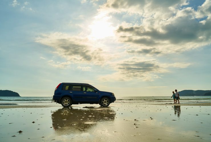 blue suv on beach during daytime