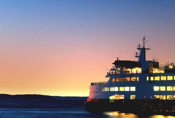 lighted cruiseship on sea taken during golden hour