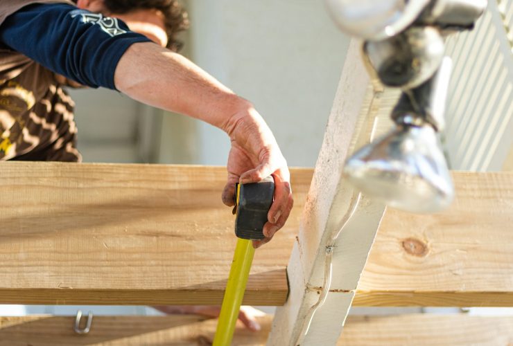 person holding black and green power tool