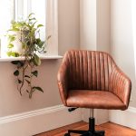 brown and black rolling chair beside green plant