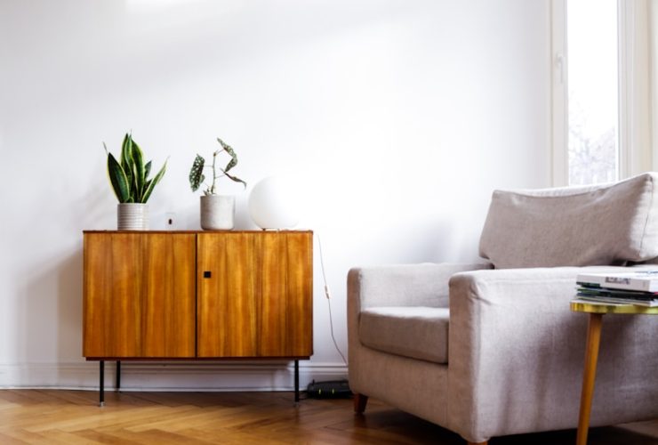brown wooden table beside gray couch