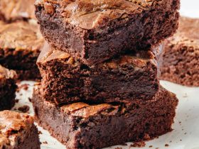 a pile of brownies sitting on top of a white plate